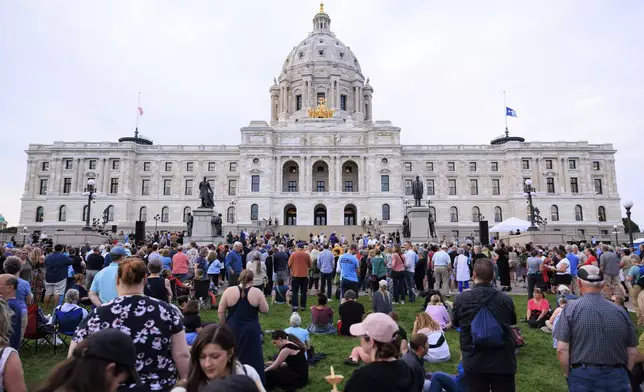 People attend a candlelight vigil for former House Speaker Melissa Hortman and her husband Mark, who were fatally shot, at the state Capitol, Wednesday, June 18, 2025, in St. Paul, Minn. (AP Photo/Nikolas Liepins)