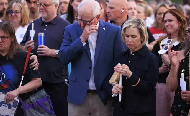 Minnesota Gov. Tim Walz and his wife Gwen Walz attend a candlelight vigil for former House Speaker Melissa Hortman and her husband Mark, who were fatally shot, at the state Capitol, Wednesday, June 18, 2025, in St. Paul, Minn. (AP Photo/Nikolas Liepins)