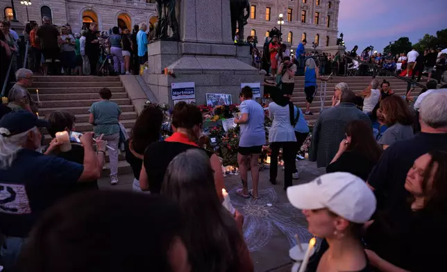 People attend a candlelight vigil for former House Speaker Melissa Hortman and her husband Mark, who were fatally shot, at the state Capitol, Wednesday, June 18, 2025, in St. Paul, Minn. (AP Photo/Nikolas Liepins)