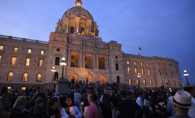 People attend a candlelight vigil for former House Speaker Melissa Hortman and her husband Mark, who were fatally shot, at the state Capitol, Wednesday, June 18, 2025, in St. Paul, Minn. (AP Photo/Nikolas Liepins)