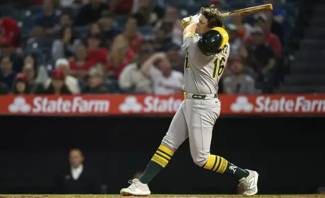 Athletics' Nick Kurtz loses his helmet swinging during the eighth inning of a baseball game against the Los Angeles Angels, Monday, June 9, 2025, in Anaheim, Calif. (AP Photo/William Liang)