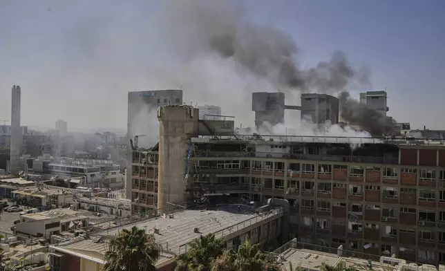 Smokes raises from a building of the Soroka hospital complex after it was hit by a missile fired from Iran in Be'er Sheva, Israel, Thursday, June 19, 2025. (AP Photo/Leo Correa)