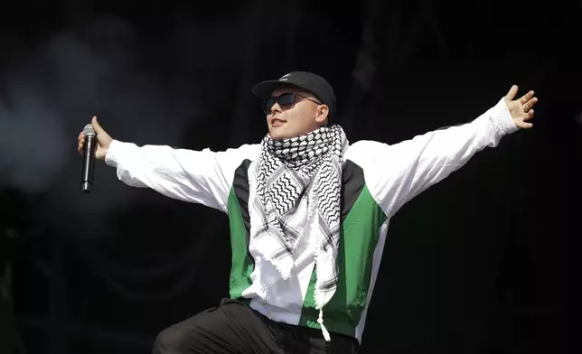 Liam Og of the hip hop trio Kneecap performs during the Glastonbury Festival in Worthy Farm, Somerset, England, Saturday, June 28, 2025. (Scott A Garfitt/Invision/AP)