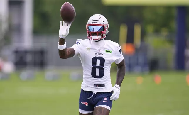 New England Patriots wide receiver Stefon Diggs tosses the ball after catching a pass during an NFL football practice, Monday, June 9, 2025, in Foxborough, Mass. (AP Photo/Charles Krupa)