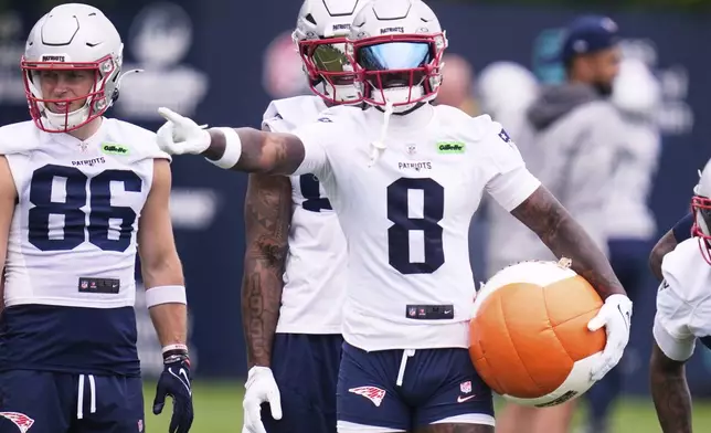 New England Patriots wide receiver Stefon Diggs prepares to run a drill with a heavy ball during an NFL football practice, Monday, June 9, 2025, in Foxborough, Mass. (AP Photo/Charles Krupa)
