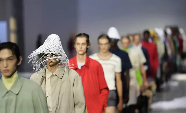 Models wear creations as part of the men's Prada Spring-Summer 2026 collection, that was presented in Milan, Italy, Sunday, June 22, 2025. (AP Photo/Luca Bruno)