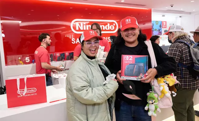 In this photo provided by Nintendo of America, fans pose with their Nintendo Switch 2 systems at the brand-new Nintendo SAN FRANCISCO store in Union Square following the global launch of the system. Nintendo Switch 2, the seamlessly social, all-in-one Nintendo platform, is available now.