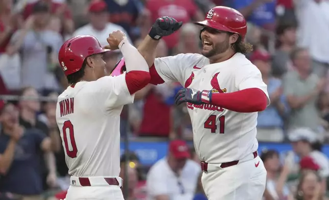 St. Louis Cardinals' Alec Burleson (41) is congratulated by teammate Masyn Winn (0) after hitting a two-run home run during the fifth inning of a baseball game against the Chicago Cubs Monday, June 23, 2025, in St. Louis. (AP Photo/Jeff Roberson)