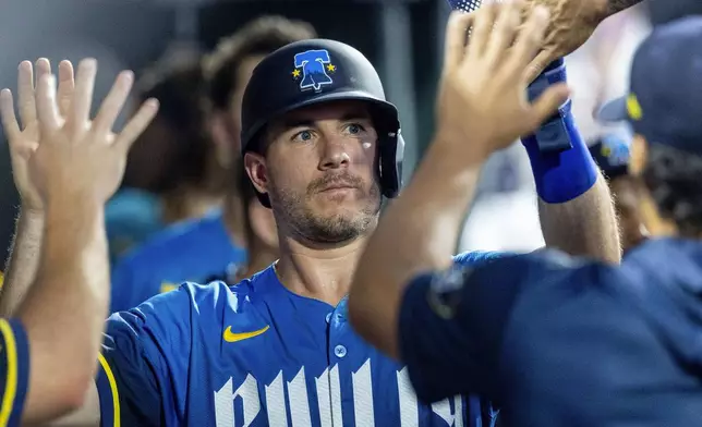 Philadelphia Phillies' J.T. Realmuto celebrates his run on an RBI single by Brandon Marsh in the fourth inning of a baseball game against the New York Mets, Friday, June 20, 2025, in Philadelphia. (AP Photo/Laurence Kesterson)