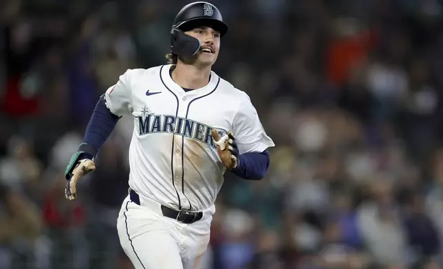 Seattle Mariners' Cole Young runs to first base after hitting a single to record his first major league hit during the ninth inning of a baseball game against the Minnesota Twins, Saturday, May 31, 2025, in Seattle. (AP Photo/Ryan Sun)