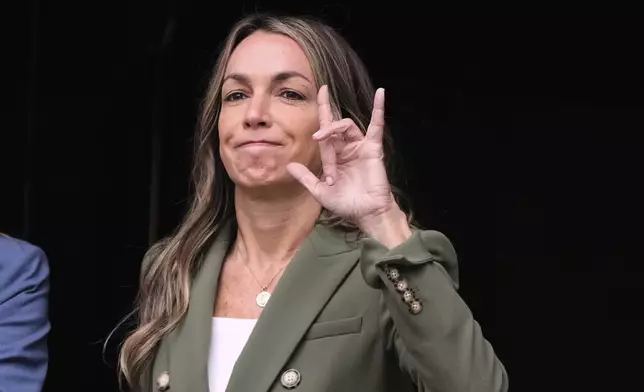 Karen Read gestures to her supporters while departing Norfolk Superior Court during jury deliberations at her trial, Tuesday, June 17, 2025, in Dedham, Mass. (AP Photo/Charles Krupa)