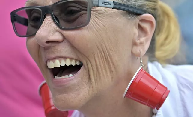 Karen Read supporter Bonnie Fitzgibbon of Chelmsford, MA, wears earrings mocking the investigation into the death of John O'Keefe outside the courthouse on the third day of jury deliberations in Read's trial at Norfolk Superior Court, Wednesday, June 18, 2025, in Dedham, Mass. (AP Photo/Josh Reynolds)