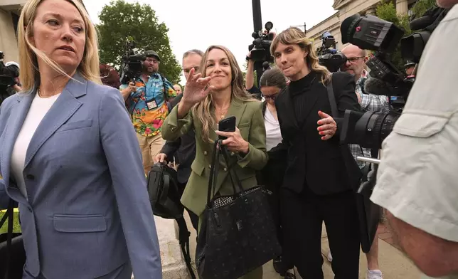 Karen Read gestures to her supporters while departing Norfolk Superior Court during jury deliberations at her trial, Tuesday, June 17, 2025, in Dedham, Mass. (AP Photo/Charles Krupa)