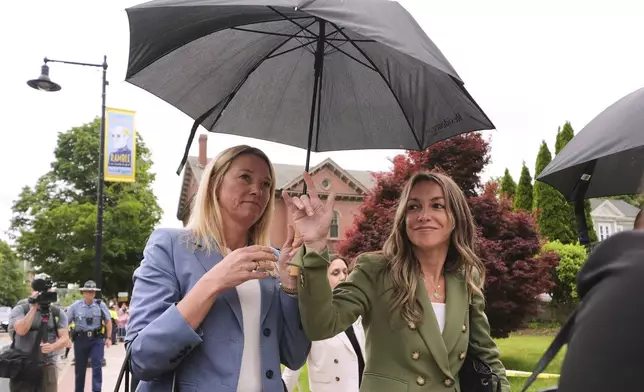 Karen Read gestures to her supporters while arriving at Norfolk Superior Court during jury deliberations at her trial, Tuesday, June 17, 2025, in Dedham, Mass. (AP Photo/Charles Krupa)