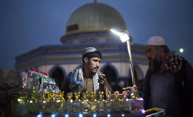 People shop in a market the day before Eid al-Adha in Kabul, Afghanistan, Friday, June 6, 2025. (AP Photo/Ebrahim Noroozi)