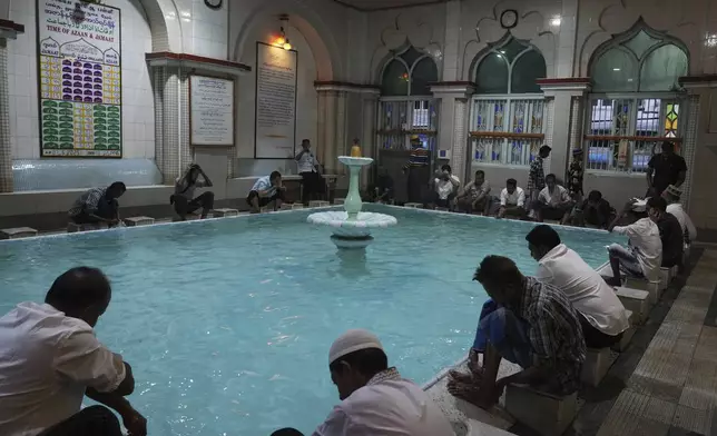 Myanmar Muslims perform ablution before offering Eid al-Adha prayers at a mosque Saturday, June 7, 2025, in Yangon, Myanmar. (AP Photo/Thein Zaw)