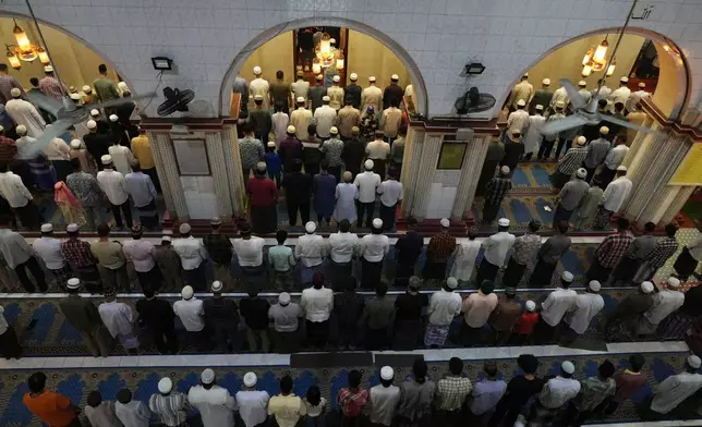 Myanmar Muslims offer a prayer to mark celebrations of Eid al-Adha at a mosque Saturday, June 7, 2025, in Yangon, Myanmar. (AP Photo/Thein Zaw)
