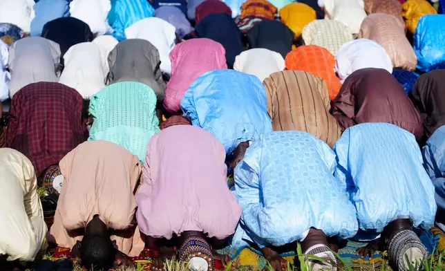 Nigerian Muslims attend Eid al-Adha prayers in an open field in Lagos, Nigeria, Friday, June 6, 2025. (AP Photo/Sunday Alamba)