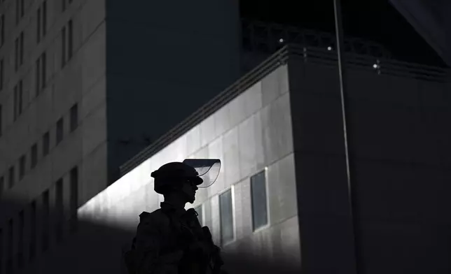 A U.S. Marine stands guard outside the downtown Metropolitan Detention Center Tuesday, June 17, 2025, in Los Angeles. (AP Photo/Wally Skalij)