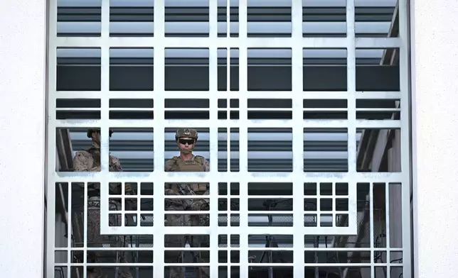 A member of the U.S. military stands guard at the downtown Metropolitan Detention Center Tuesday, June 17, 2025, in Los Angeles. (AP Photo/Wally Skalij)