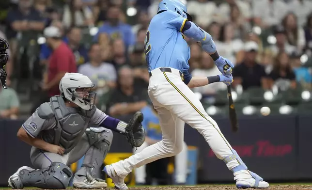 Milwaukee Brewers' Christian Yelich hits a two-run double during the eighth inning of a baseball game against the Colorado Rockies, Friday, June 27, 2025, in Milwaukee. (AP Photo/Aaron Gash)