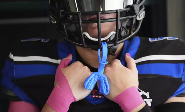 Detroit Prowl's Sydney Hebel waits in the locker room to take the field before an AWFL women's football game against the Lansing Legacy in Allen Park, Mich., Saturday, May 10, 2025. (AP Photo/Paul Sancya)