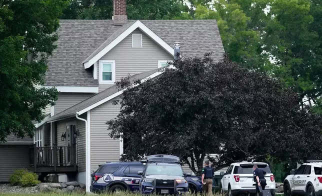 Law enforcement officers investigate the home of shooting suspect Vance Boelter, Sunday, June 15, 2025, in Green Isle, Minn. (AP Photo/George Walker IV)