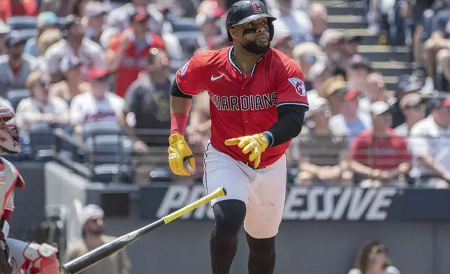 Cleveland Guardians' Carlos Santana watches his three-run home run off Cincinnati Reds starting pitcher Nick Lodolo during the third inning of a baseball game, Wednesday, June 11, 2025, in Cleveland. (AP Photo/Phil Long)