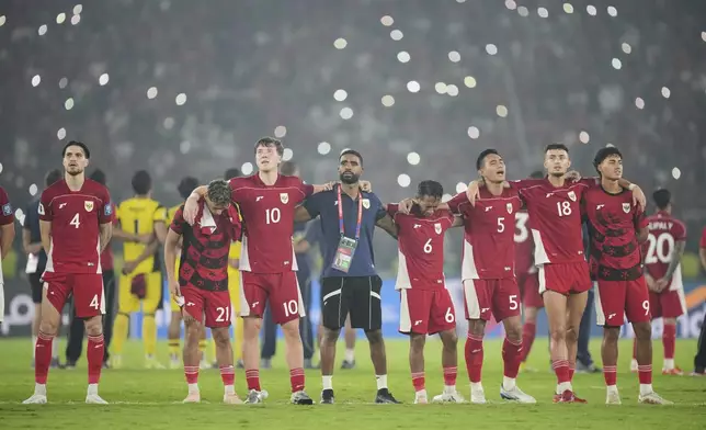 Indonesia's players and team officials celebrate their victory over China during the World Cup 2026 group C Asia qualifying soccer match between Indonesia and China at Gelora Bung Karno Main Stadium in Jakarta, Indonesia, Thursday, June 5, 2025. (AP Photo/Tatan Syuflana)
