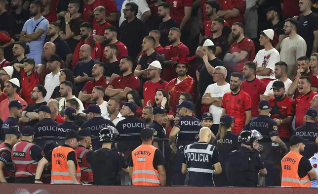 Albanian police secure an area of the tribune during a World Cup qualifying soccer match between Albania and Serbia, Saturday, June 7, 2025, at Air Albania stadium in Tirana, Albania. (AP Photo/Vlasov Sulaj)