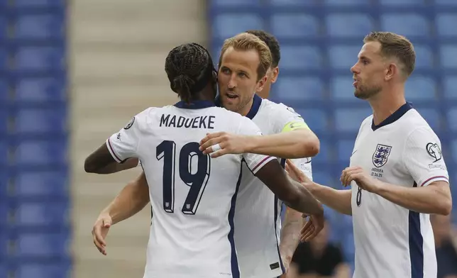 England's Harry Kane, center, celebrates with teammates after scoring his side's opening goal during a World Cup 2026 group K qualifying soccer match between Andorra and England at the RCDE Stadium in Barcelona, Spain, Saturday, June 7, 2025. (AP Photo/Joan Monfort)