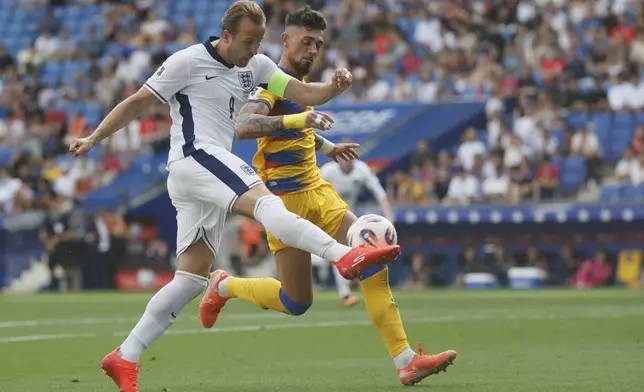 Andorra's Christian Garcia, right, tries to block a shot from England's Harry Kane during a World Cup 2026 group K qualifying soccer match between Andorra and England at the RCDE Stadium in Barcelona, Spain, Saturday, June 7, 2025. (AP Photo/Joan Monfort)