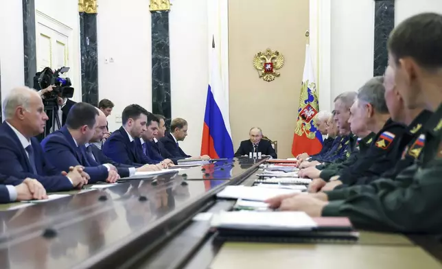 FILE - Russian President Vladimir Putin, center, chairs a meeting on a state arms program in Moscow, on Thursday, June 12, 2025. (Vyacheslav Prokofyev, Sputnik, Kremlin Pool Photo via AP)