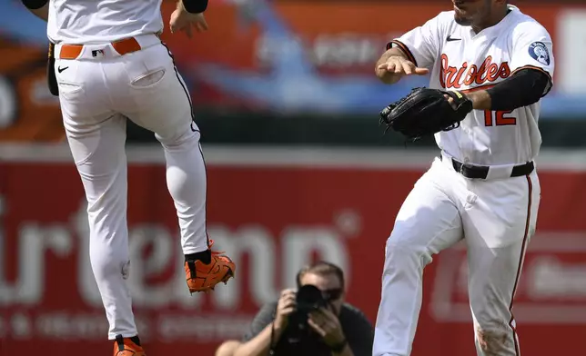 Baltimore Orioles shortstop Gunnar Henderson (2) and right fielder Ramon Laureano (12) celebrate after a baseball game against the Tampa Bay Rays, Sunday, June 29, 2025, in Baltimore. (AP Photo/Nick Wass)