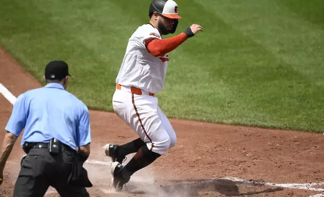 Baltimore Orioles' Gary Sanchez scores on a single by Coby Mayo during the fifth inning of a baseball game against the Tampa Bay Rays, Sunday, June 29, 2025, in Baltimore. (AP Photo/Nick Wass)