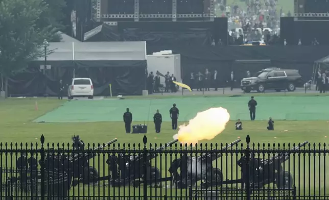 Members of the military fire cannons as part of a 21-gun salute during an event to honor the Army's 250th anniversary, coinciding with President Donald Trump's 79th birthday, Saturday, June 14, 2025, in Washington. (AP Photo/Mark Schiefelbein)
