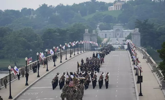 A military parade commemorating the Army's 250th anniversary, coinciding with President Donald Trump's 79th birthday, crosses over the Potomac River from Virginia into Washington, Saturday, June 14, 2025, in Washington. Robert E. Lee's home, Arlington House, stands at Arlington National Cemetery in Arlington, Va., rear. (AP Photo/Stephanie Scarbrough)