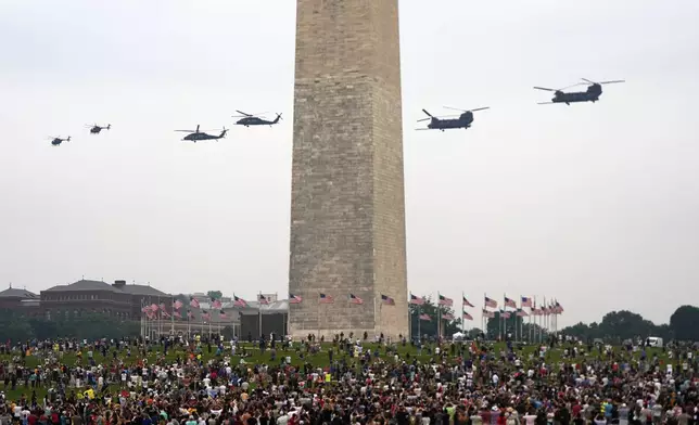 Helicopters from the 160th Special Operations Aviation Regiment, from left, MH-6 Little Bird's, MH-60 Black Hawk's, and MH-47 Chinook's, fly behind the Washington Monument during military parade commemorating the Army's 250th anniversary Saturday, June 14, 2025, in Washington. (AP Photo/Julia Demaree Nikhinson)