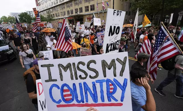 Demonstrators march during a protest taking place on the day of a military parade commemorating the Army's 250th anniversary, coinciding with President Donald Trump's 79th birthday, Saturday, June 14, 2025, in Washington. (AP Photo/Alex Brandon)