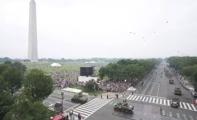 A military parade commemorating the Army's 250th anniversary and coinciding with President Donald Trump's 79th birthday, Saturday, June 14, 2025, in Washington. The Washington Monument stands left. (AP Photo/Jacquelyn Martin)