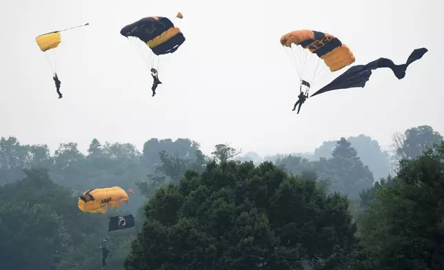 Members of the U.S. Army Parachute Team Golden Knights make their landing during an event to honor the Army's 250th anniversary, coinciding with President Donald Trump's 79th birthday, Saturday, June 14, 2025, in Washington. (AP Photo/Mark Schiefelbein)