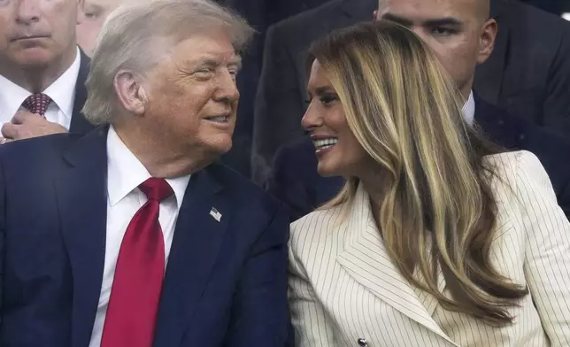 President Donald Trump and first lady Melania Trump attend a military parade commemorating the Army's 250th anniversary, coinciding with his 79th birthday, Saturday, June 14, 2025, in Washington. (AP Photo/Julia Demaree Nikhinson)