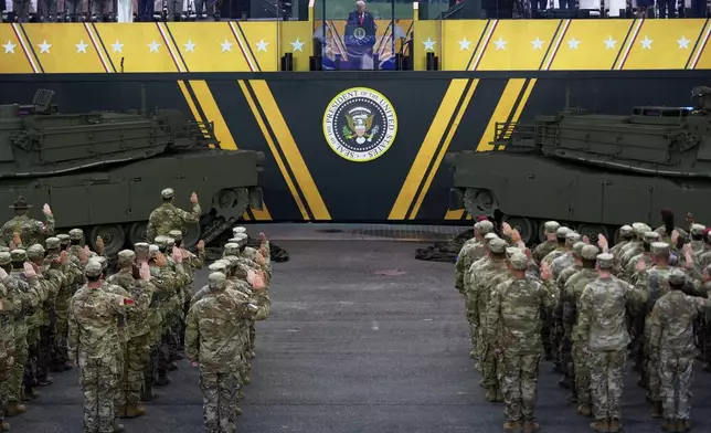 President Donald Trump participates in a reenlistment ceremony for Army soldiers during a military parade commemorating the Army's 250th anniversary Saturday, June 14, 2025, in Washington. (AP Photo/Julia Demaree Nikhinson)