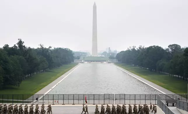 A military parade commemorating the Army's 250th anniversary, coinciding with President Donald Trump's 79th birthday, Saturday, June 14, 2025, in Washington. The Washington Monument stands center. (AP Photo/Stephanie Scarbrough)
