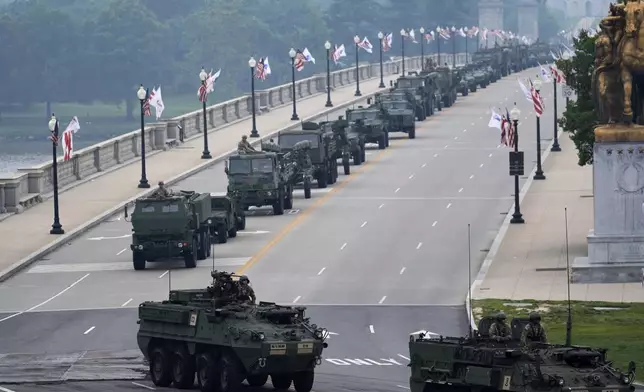 A military parade commemorating the Army's 250th anniversary, coinciding with President Donald Trump's 79th birthday, crosses over the Potomac River from Virginia into Washington, Saturday, June 14, 2025, in Washington. (AP Photo/Stephanie Scarbrough)