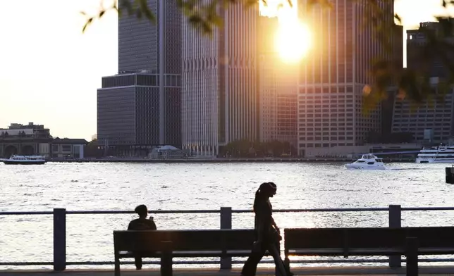 The sun sets along the East River in the Brooklyn borough of New York, Wednesday, June 4, 2025, during an air quality alert issued for the New York region due to wildfire smoke from Canada. (AP Photo/Heather Khalifa)