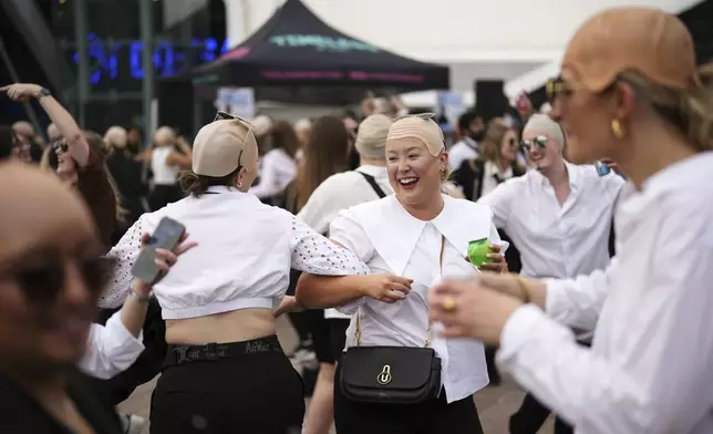 Fans dance in front of the O2 Arena prior to a performance by Pitbull on Monday, June 9, 2025, in London. (Photo by Scott A Garfitt/Invision/AP)