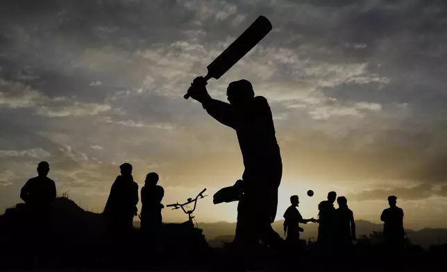 Afghans play cricket at the Chaman-e-Hozari Park in Kabul, Afghanistan, Friday, May 30, 2025. (AP Photo/Ebrahim Noroozi)