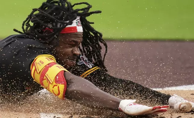 Pittsburgh Pirates' Oneil Cruz slides into home, scoring from second base off an RBI single by Bryan Reynolds during the first inning of a baseball game against the San Diego Padres Saturday, May 31, 2025, in San Diego. (AP Photo/Gregory Bull)