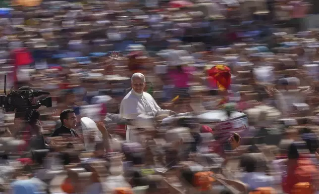Pope Leo XIV arrives on his pope mobile before celebrating a Mass for the Jubilee of Families in St. Peter's Square, at the Vatican, Sunday, June 1, 2025. (AP Photo/Andrew Medichini)